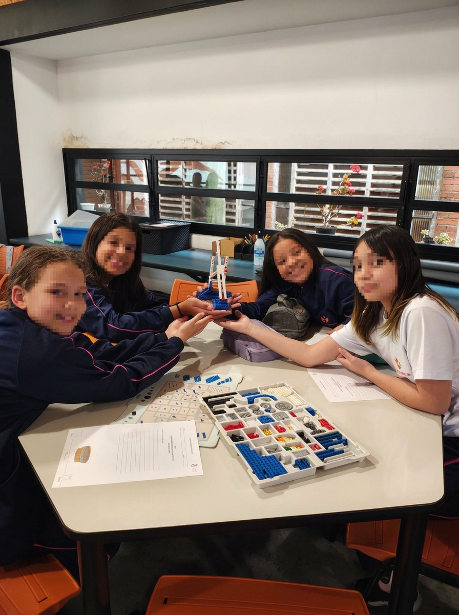AFESU students assembling a robotics prototype with a block kit